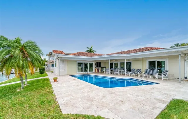 a swimming pool with outdoor seating and garden