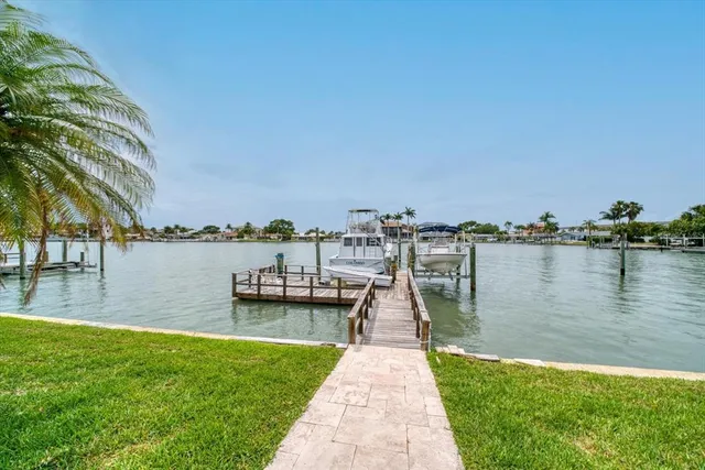 a swimming pool with outdoor seating and garden