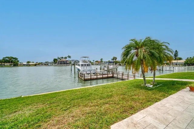a view of a house with a yard and lake view