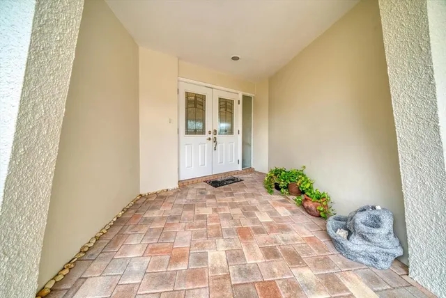 a view of a hallway with dining area and chandelier