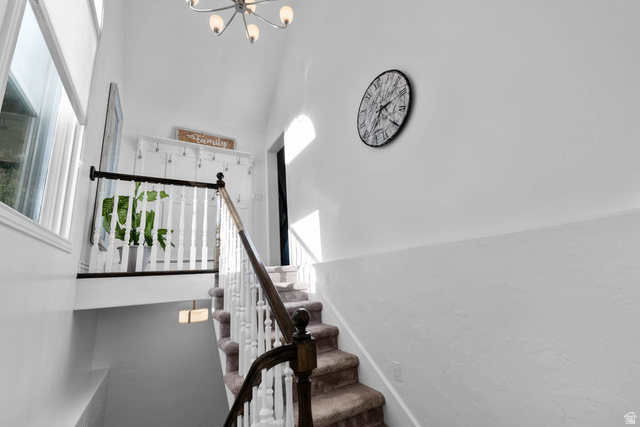 10686 South Covered Brg Cyn Road, Unit 14 Spanish Fork, UT 84660 - Photo 26 of 44 Multi-level staircase featuring carpeted treads, white balusters, and a dark wood handrail