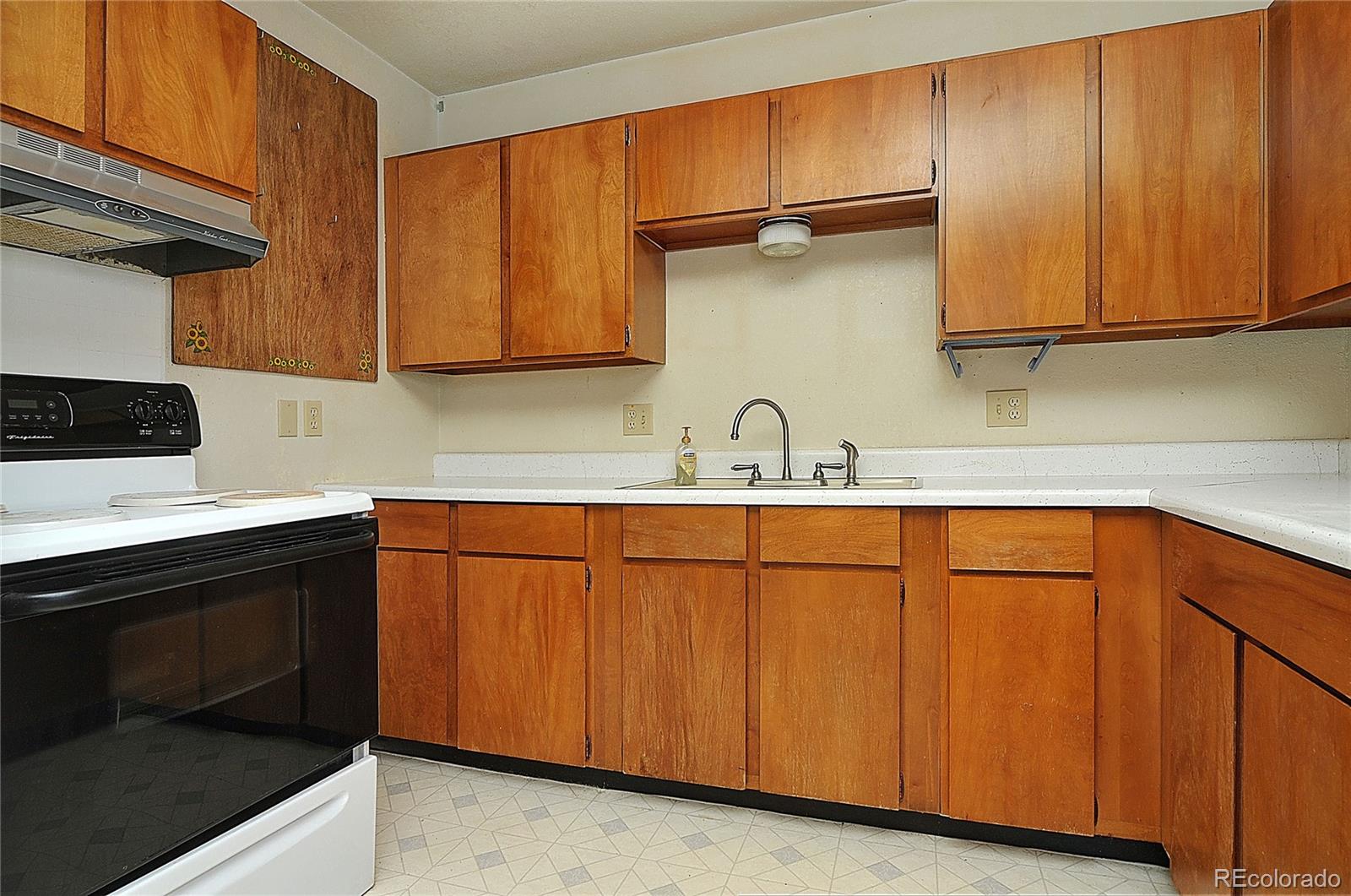 114 Loop Drive Howard, CO 81233 - Photo 14 of 24 a kitchen with stainless steel appliances granite countertop wooden cabinets a sink and a stove