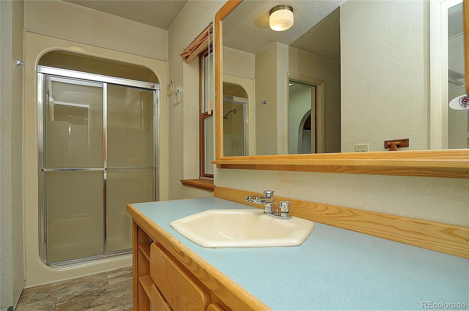 114 Loop Drive Howard, CO 81233 - Photo 17 of 24 a bathroom with a sink and a mirror