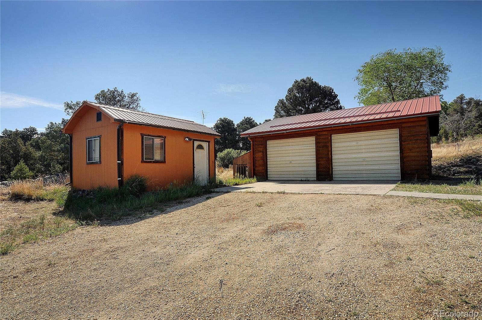 114 Loop Drive Howard, CO 81233 - Photo 2 of 24 a front view of a house with a yard and garage
