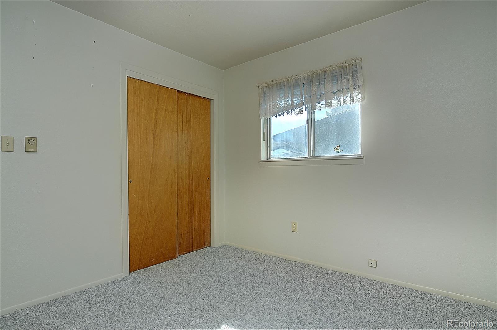 114 Loop Drive Howard, CO 81233 - Photo 21 of 24 an empty room with windows and chandelier