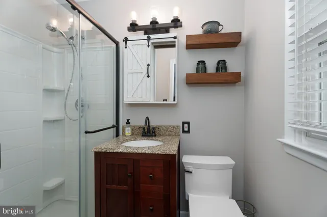 a bathroom with a toilet sink and mirror