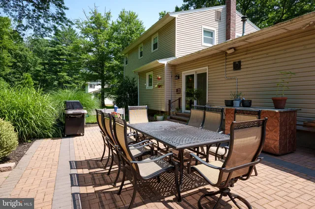 a view of a patio with table and chairs with wooden floor and fence