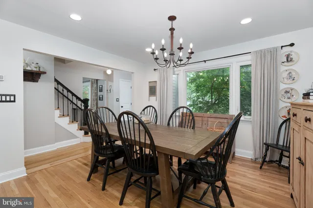 a view of a a dining room with furniture window and wooden floor