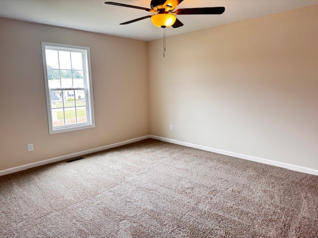 62 Modena Place Decherd, TN 37324 - Photo 7 of 14 an empty room with a window and a ceiling fan