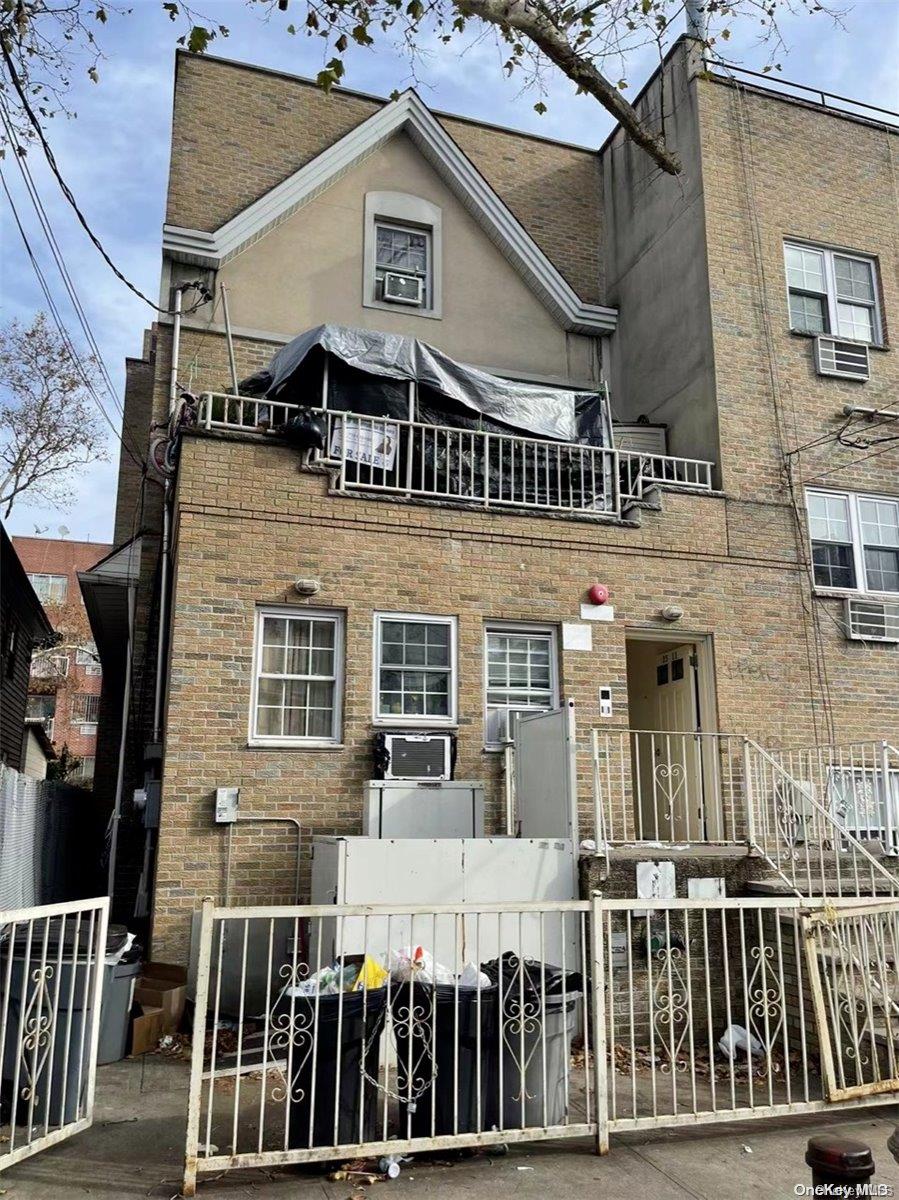 a front view of a house with a iron gate