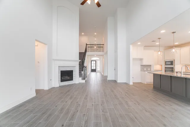 a view of a kitchen with a sink and a fireplace