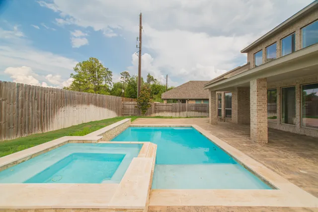 a view of a swimming pool with a chair and tables