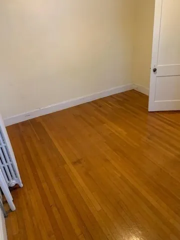 an empty room with wooden floor