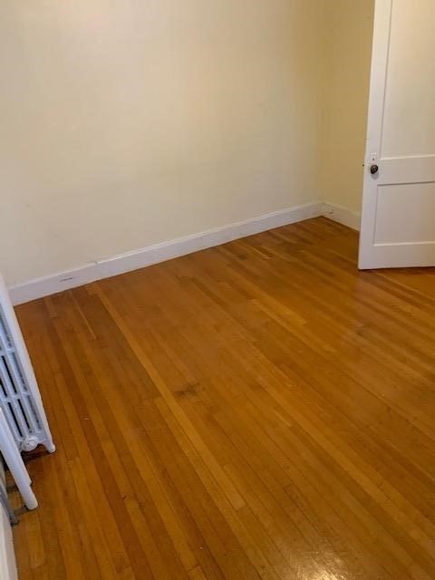 159 Grandview Avenue, Unit 1 Quincy, MA 02170 - Photo 4 of 10 an empty room with wooden floor