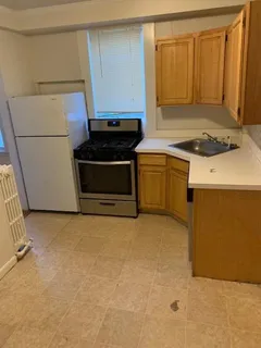 a kitchen with a stove and a refrigerator
