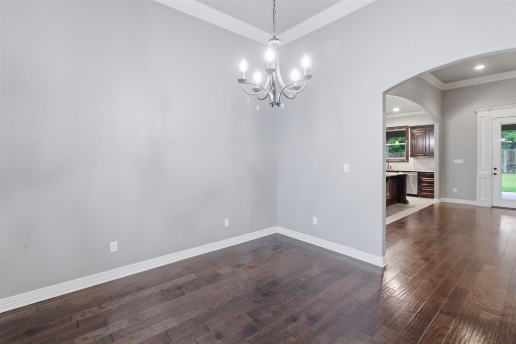 7765 Hickory Spring Lane Tyler, TX 75703 - Photo 8 of 38 Spacious interior with wood-finish flooring, light gray walls, and white crown molding