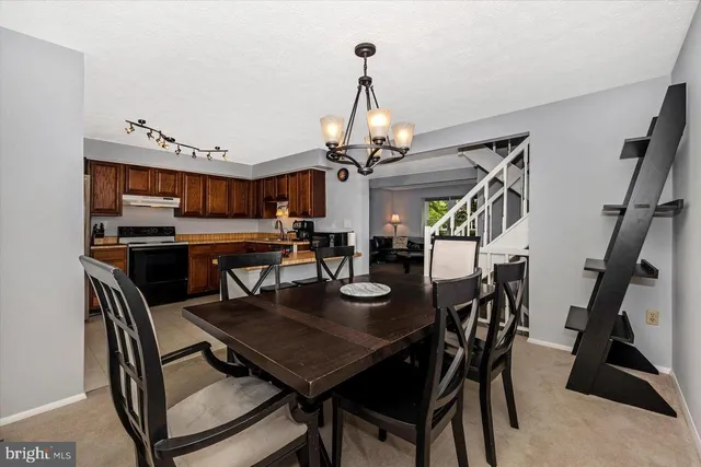 a kitchen with stainless steel appliances granite countertop a sink refrigerator and microwave