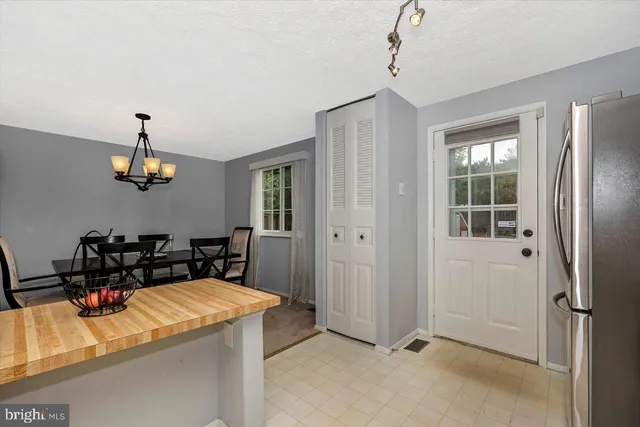 a kitchen with stainless steel appliances granite countertop a refrigerator and a stove