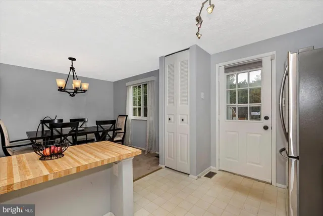 a kitchen with appliances a sink and cabinets