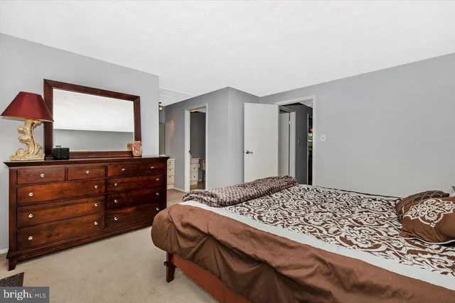 a bedroom with a bed and a lamp with closet