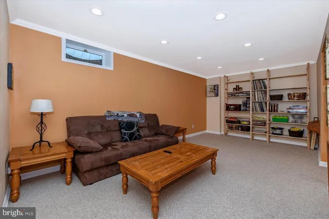 a living room with closet and a flat screen tv