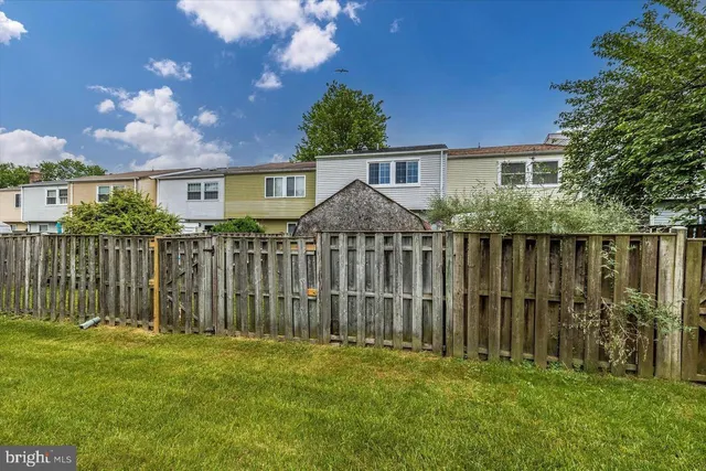 a view of a backyard with a garden and deck