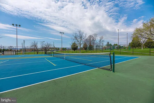 a view of a playground with basketball court