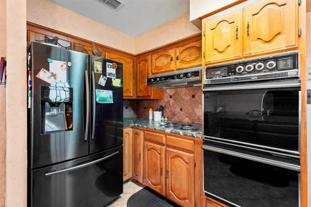 a open kitchen with stainless steel appliances granite countertop a stove a sink and a wooden floors
