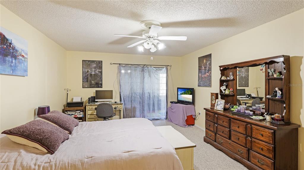 527 Spring Lakes Boulevard Bradenton, FL 34210 - Photo 14 of 41 a bedroom with furniture and a window