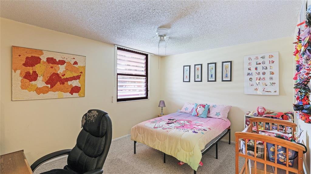 527 Spring Lakes Boulevard Bradenton, FL 34210 - Photo 18 of 41 a bedroom with a bed and a painting on the wall