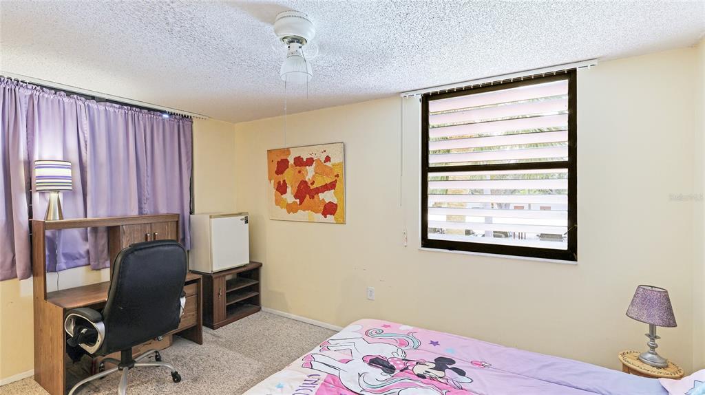527 Spring Lakes Boulevard Bradenton, FL 34210 - Photo 19 of 41 a bedroom with a bed and a window