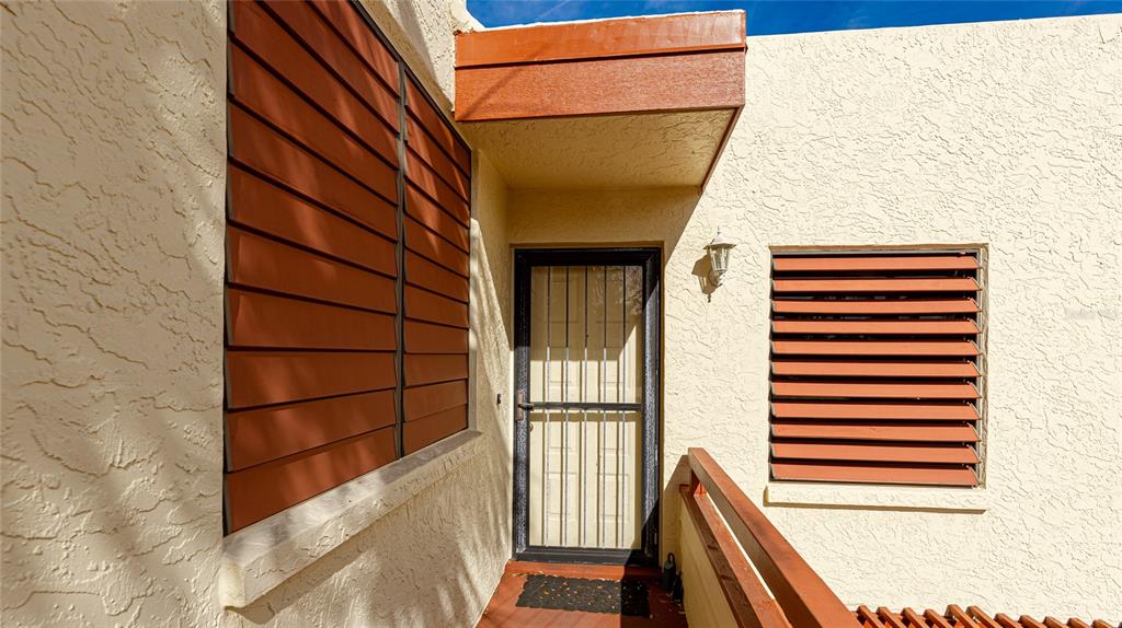 527 Spring Lakes Boulevard Bradenton, FL 34210 - Photo 22 of 41 a view of a balcony with wooden floor and fence