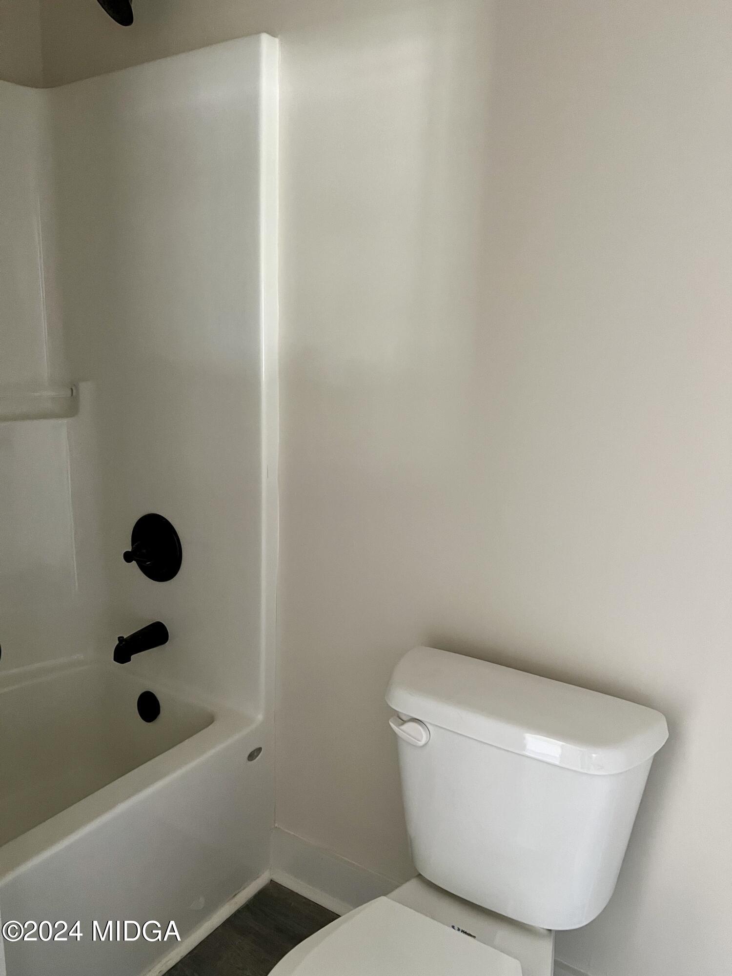 450 Walker Road Byron, GA 31008 - Photo 11 of 22 a bathroom with a toilet and a bathtub