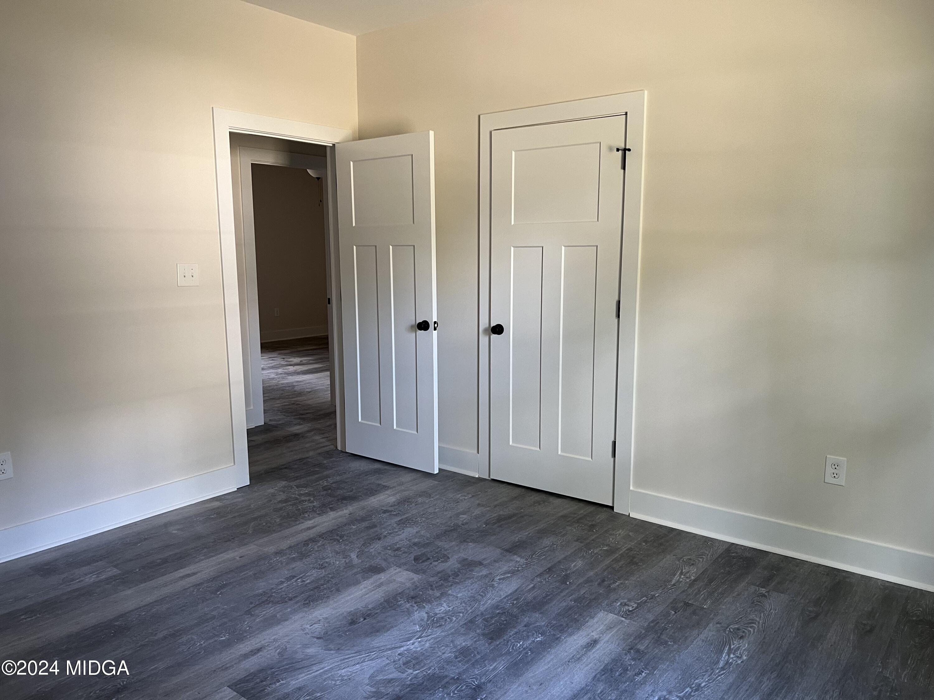 450 Walker Road Byron, GA 31008 - Photo 13 of 22 an empty room with wooden floor door