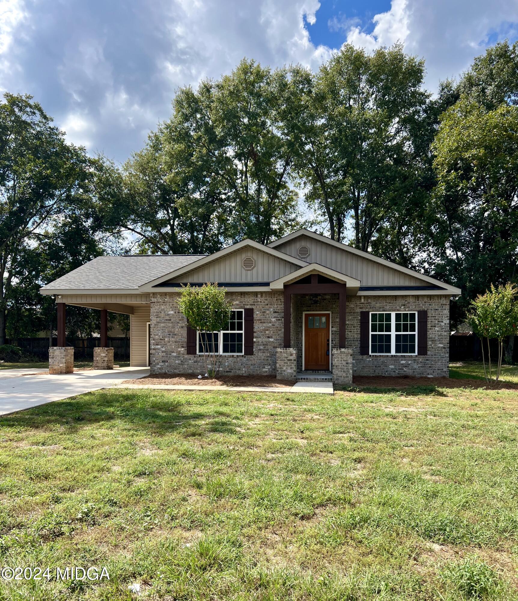 450 Walker Road Byron, GA 31008 - Photo 2 of 22 a house with trees in the background