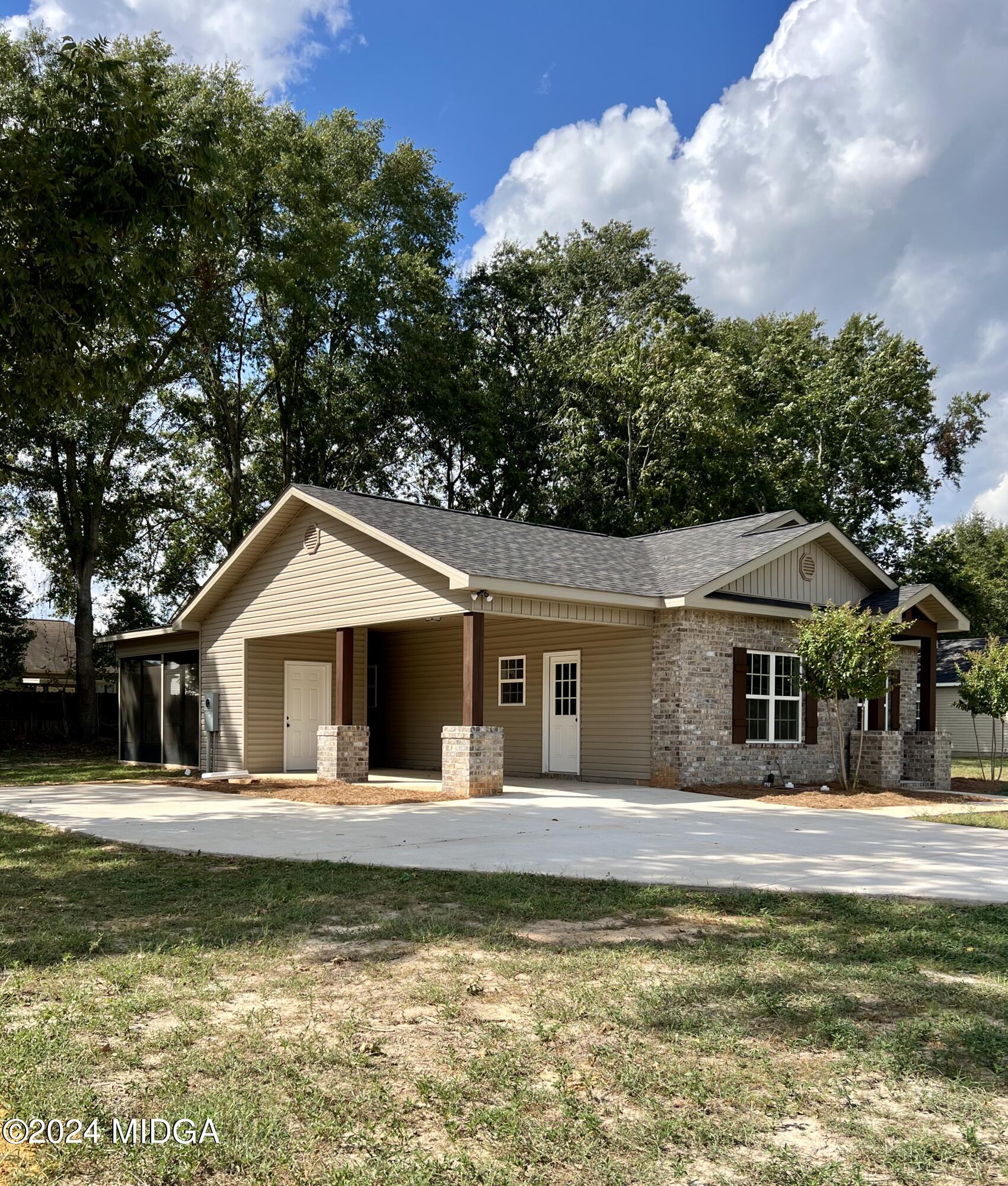 450 Walker Road Byron, GA 31008 - Photo 3 of 22 a front view of a house with a yard