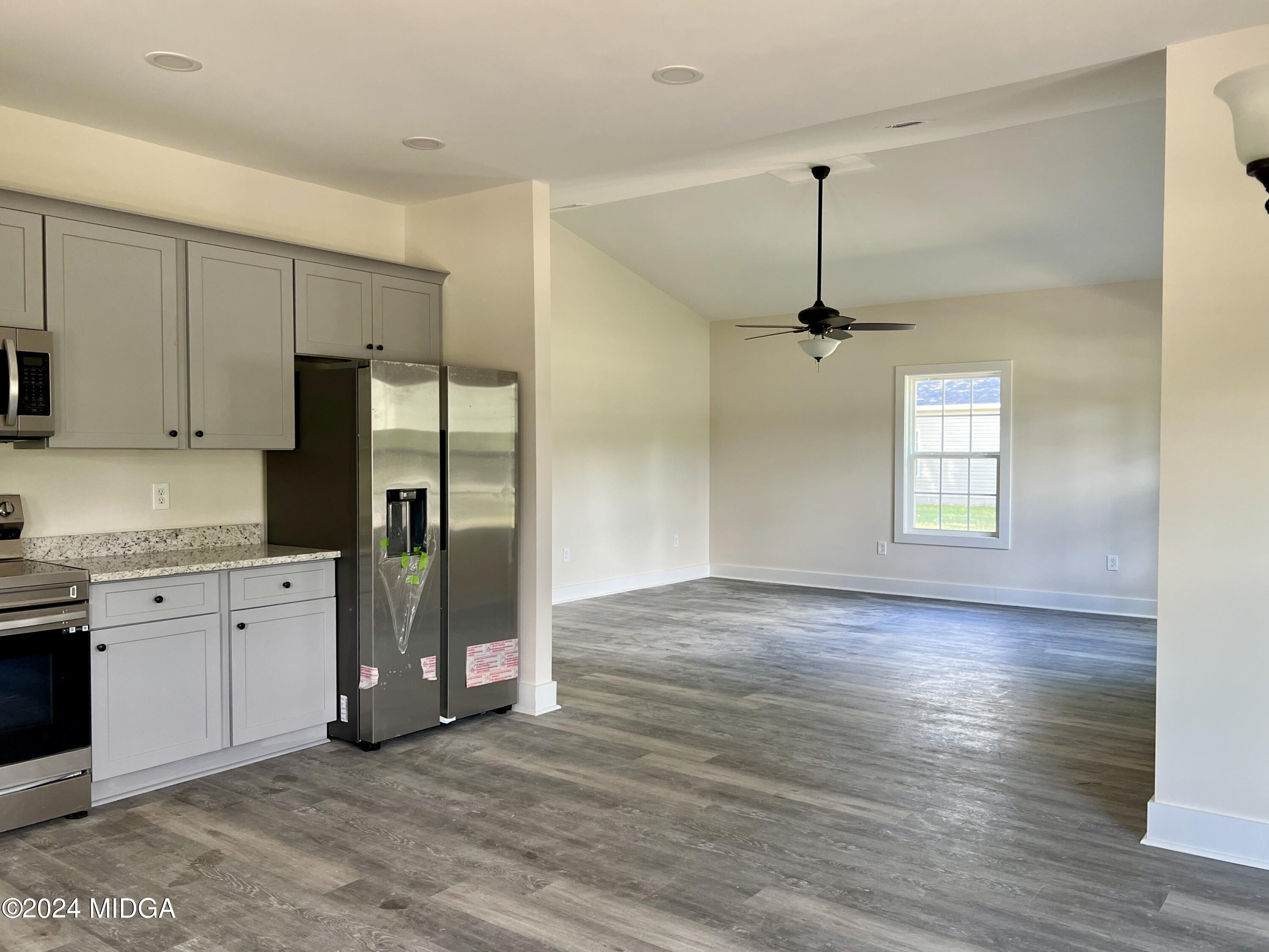 450 Walker Road Byron, GA 31008 - Photo 6 of 22 a view of a kitchen with a sink and a refrigerator