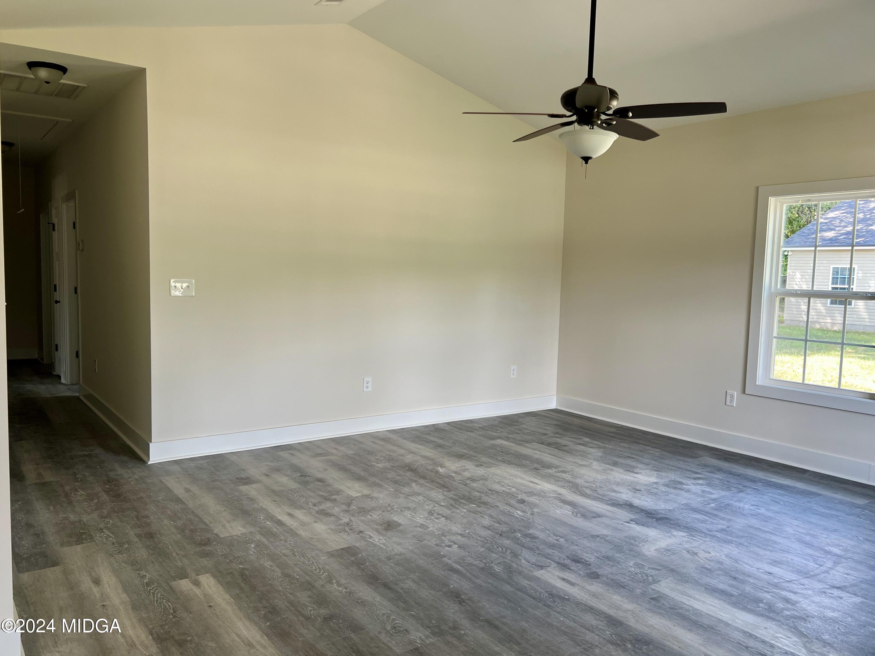 450 Walker Road Byron, GA 31008 - Photo 7 of 22 a view of an empty room with a window