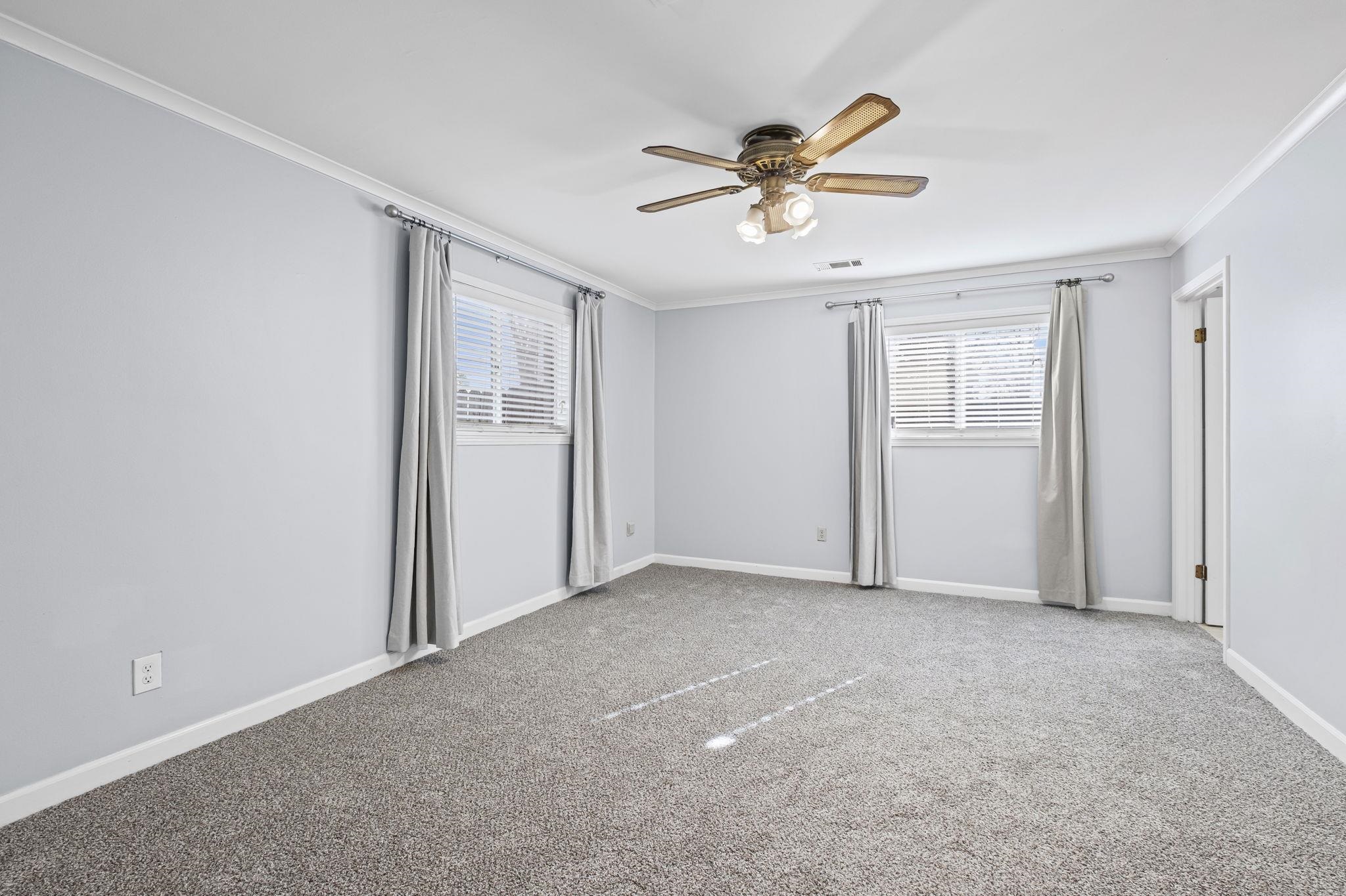 5037 Dee Road Memphis, TN 38117 - Photo 16 of 29 an empty room with windows and fan
