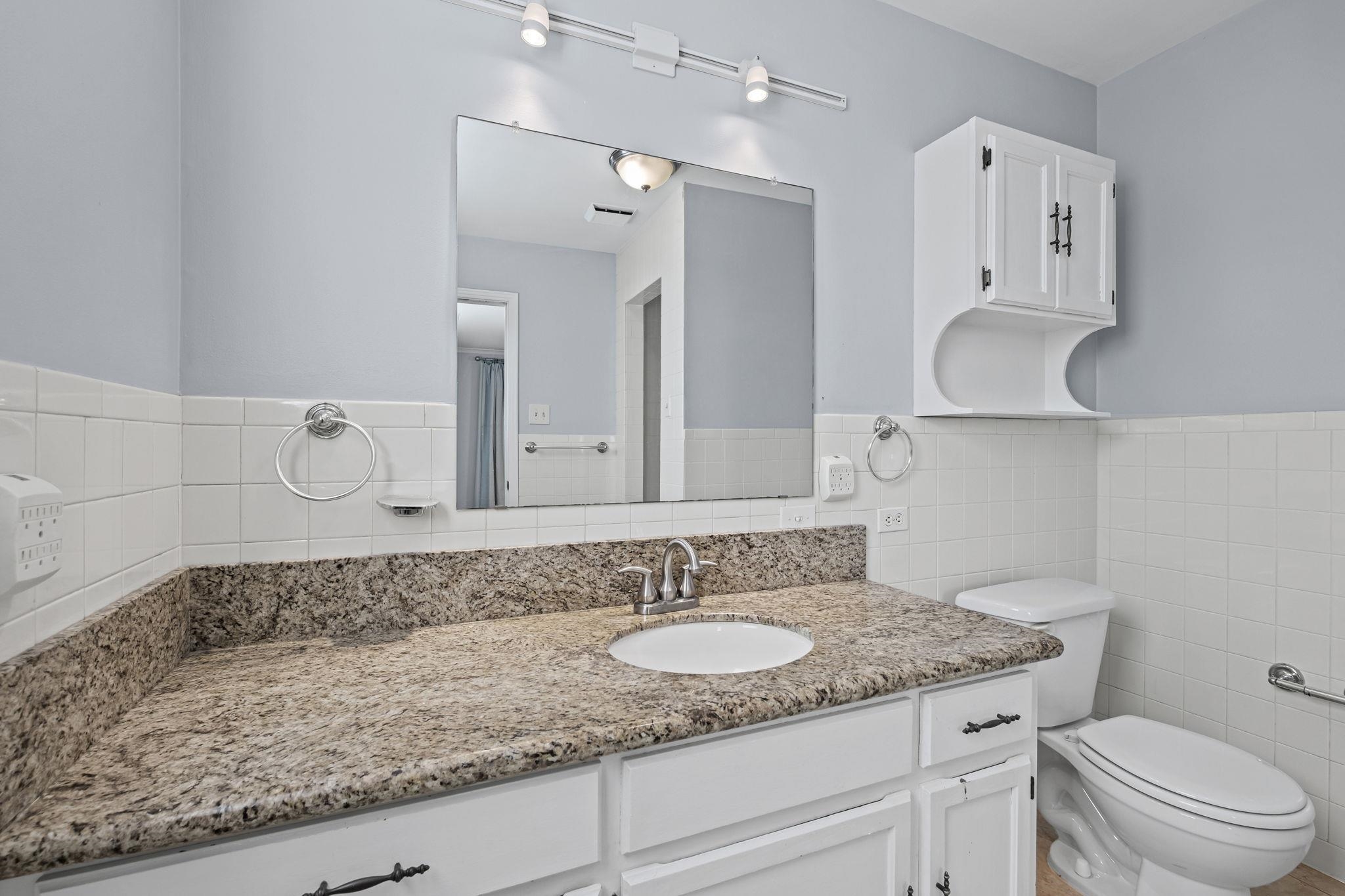 5037 Dee Road Memphis, TN 38117 - Photo 23 of 28 a bathroom with a granite countertop sink and a mirror
