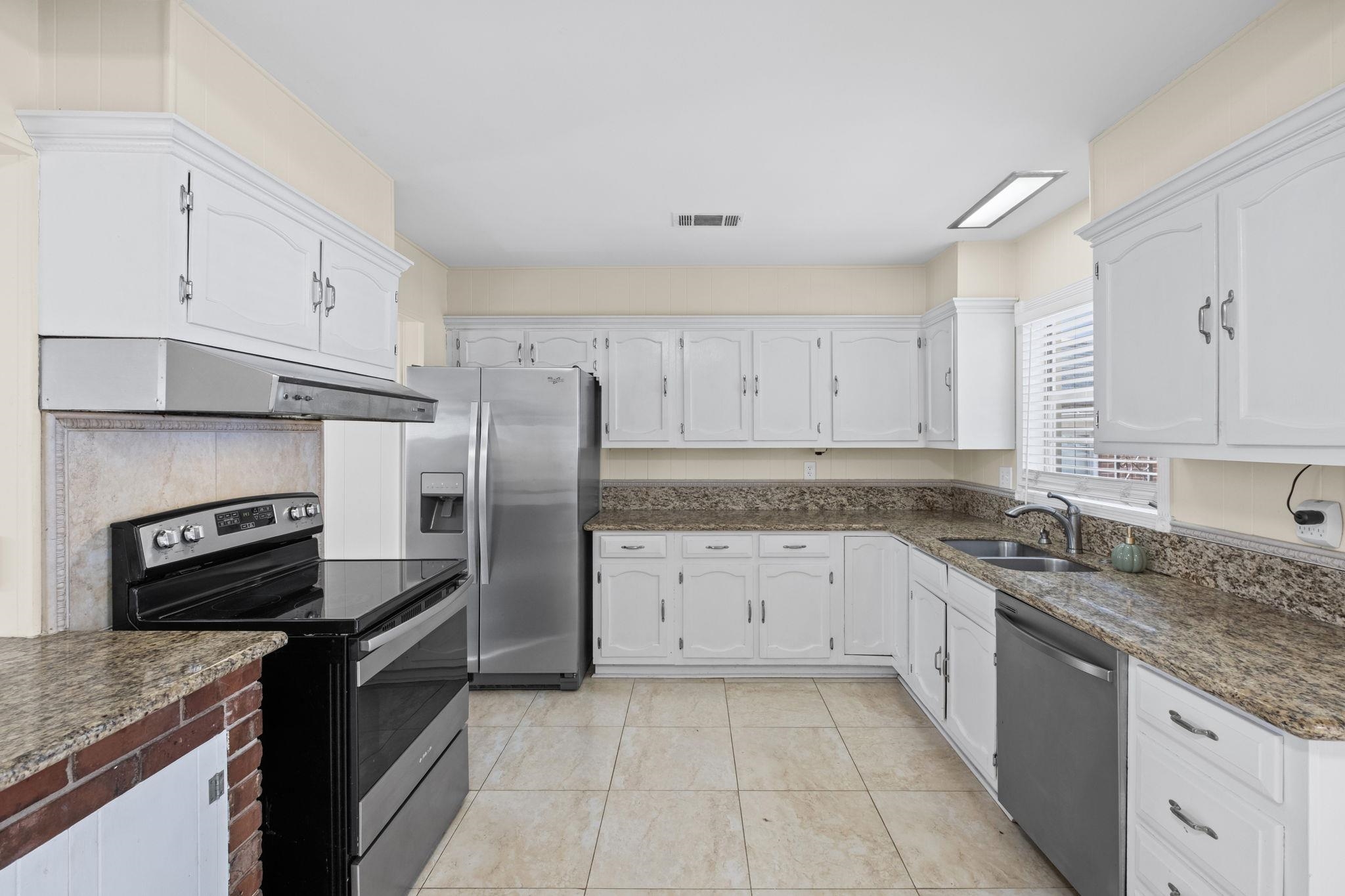 5037 Dee Road Memphis, TN 38117 - Photo 29 of 29 a kitchen with granite countertop a sink stove and refrigerator