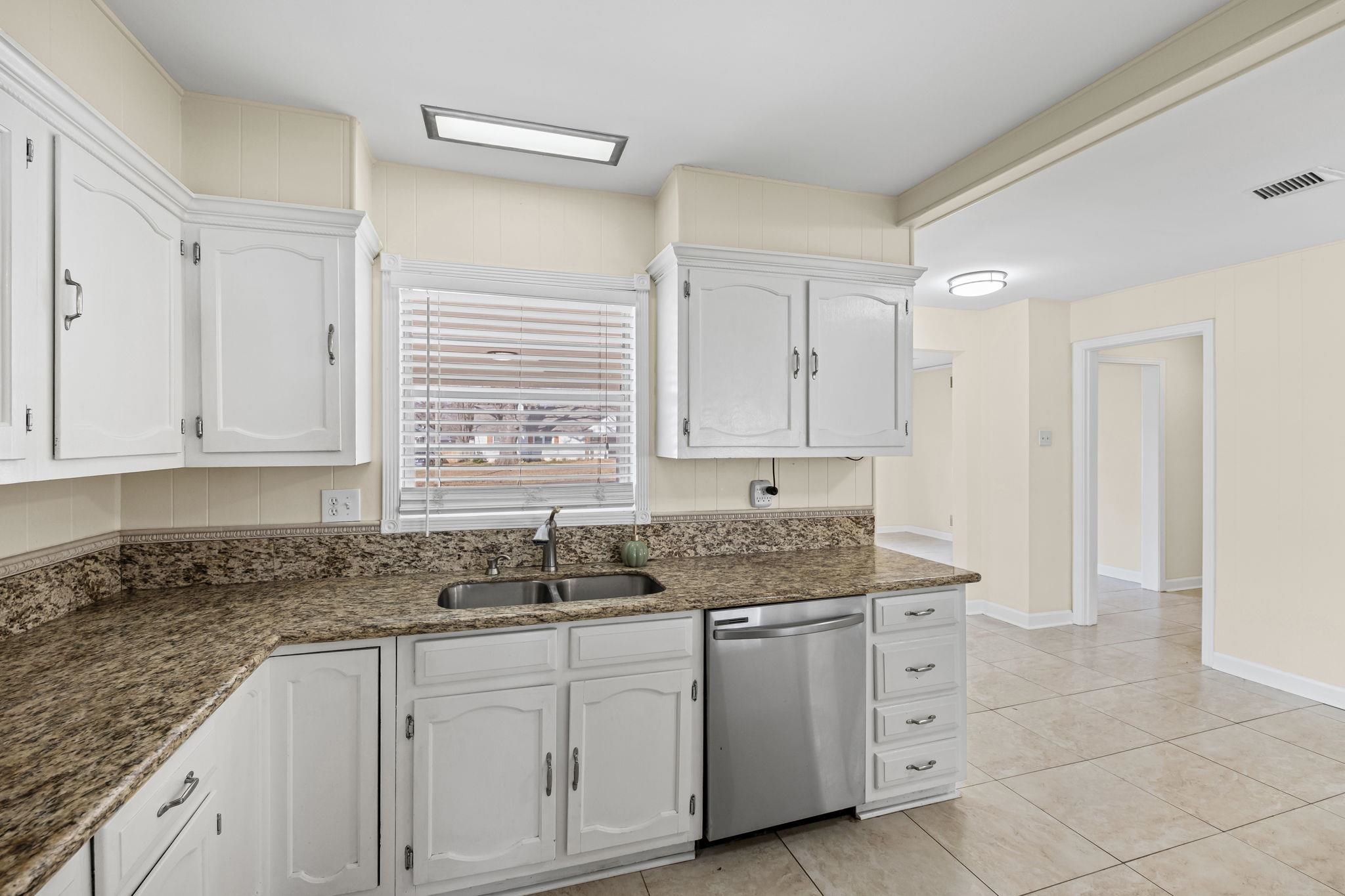5037 Dee Road Memphis, TN 38117 - Photo 6 of 29 a kitchen with granite countertop white cabinets and sink