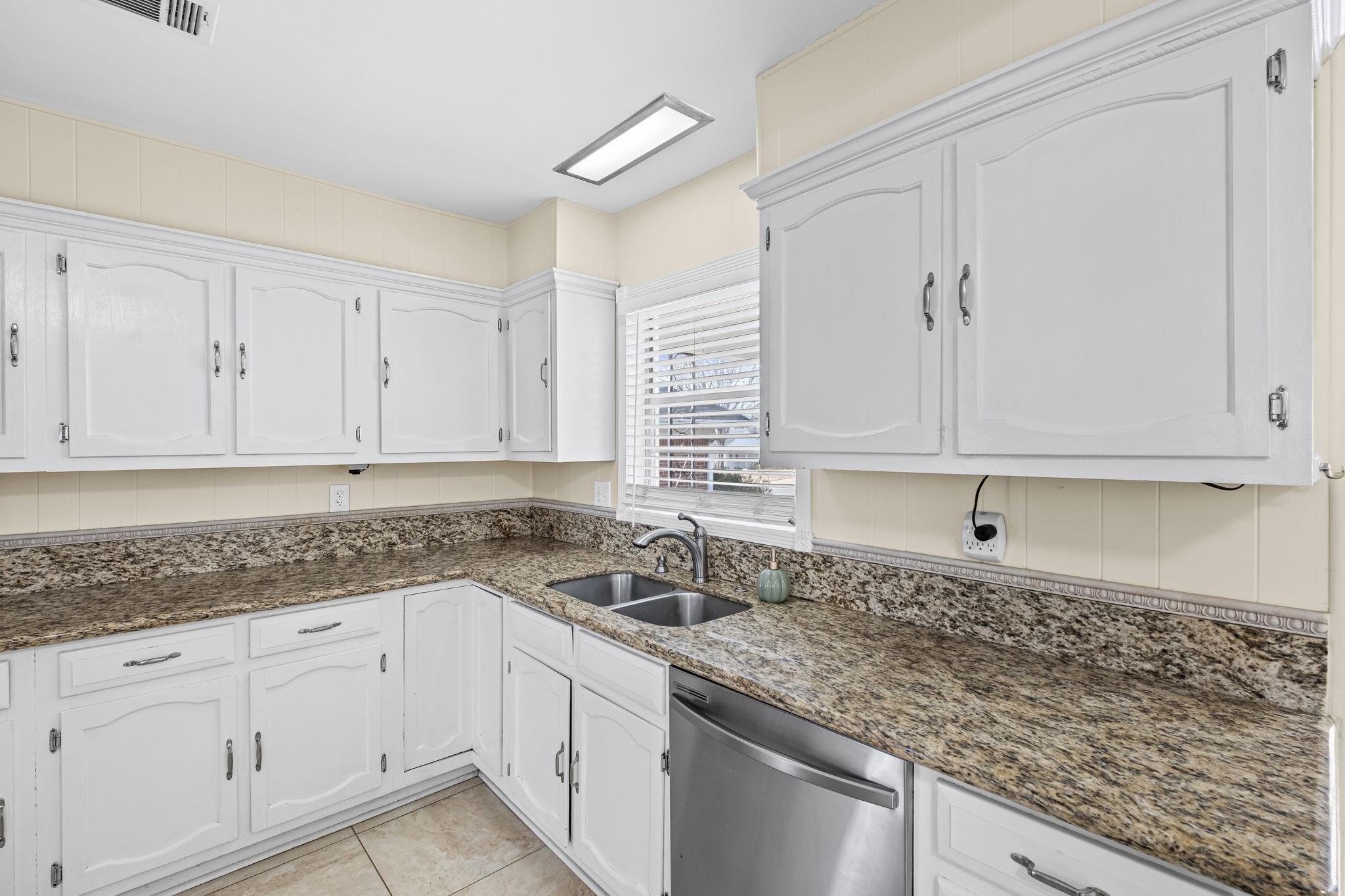 5037 Dee Road Memphis, TN 38117 - Photo 9 of 28 a kitchen with granite countertop white cabinets and a sink