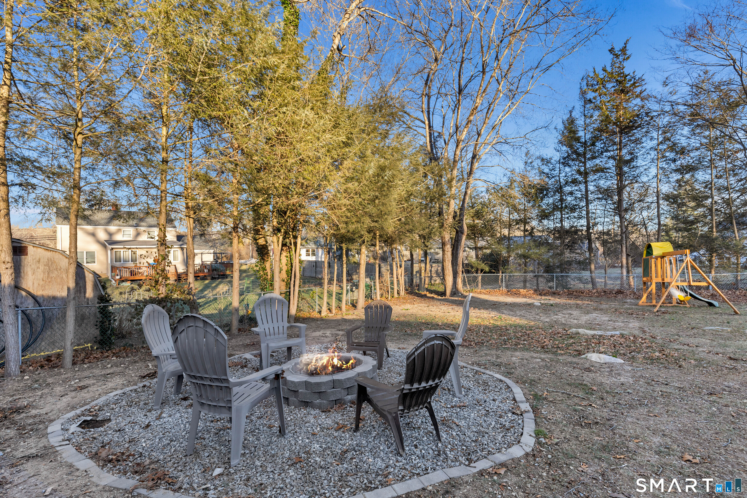 15 Country Club Drive Ledyard, CT 06339 - Photo 12 of 40 a view of a backyard with table and chairs and a fire pit