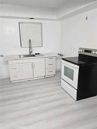 a white kitchen with sink and dishwasher