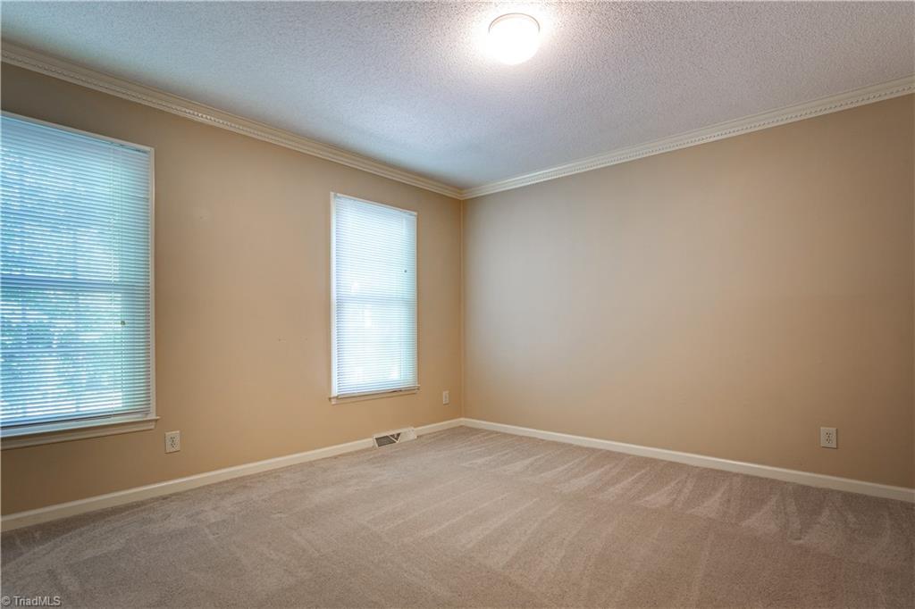607 Hobbs Road Greensboro, NC 27403 - Photo 6 of 29 Vinyl windows, recent carpet, dentil molding, and window coverings in upstairs bedroom. Just needs trim painting and flat wall paint to shine and be totally updated.
