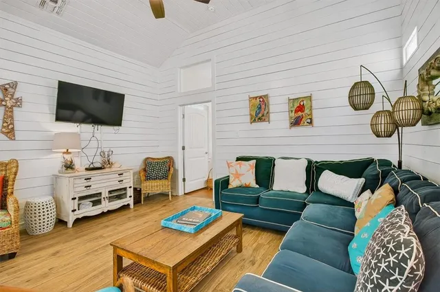 a living room with furniture and a flat screen tv