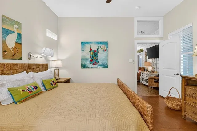 a bedroom with a bed and a large mirror