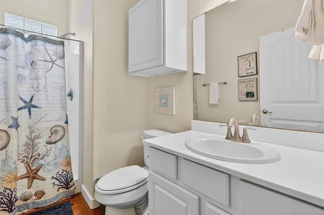 a bathroom with a sink toilet and shower