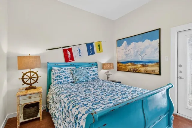 a bedroom with a bed and a painting on the wall